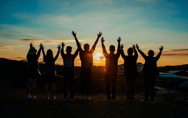 Collaborative Counselling (A photo of people with hands raised triumphantly in the air)